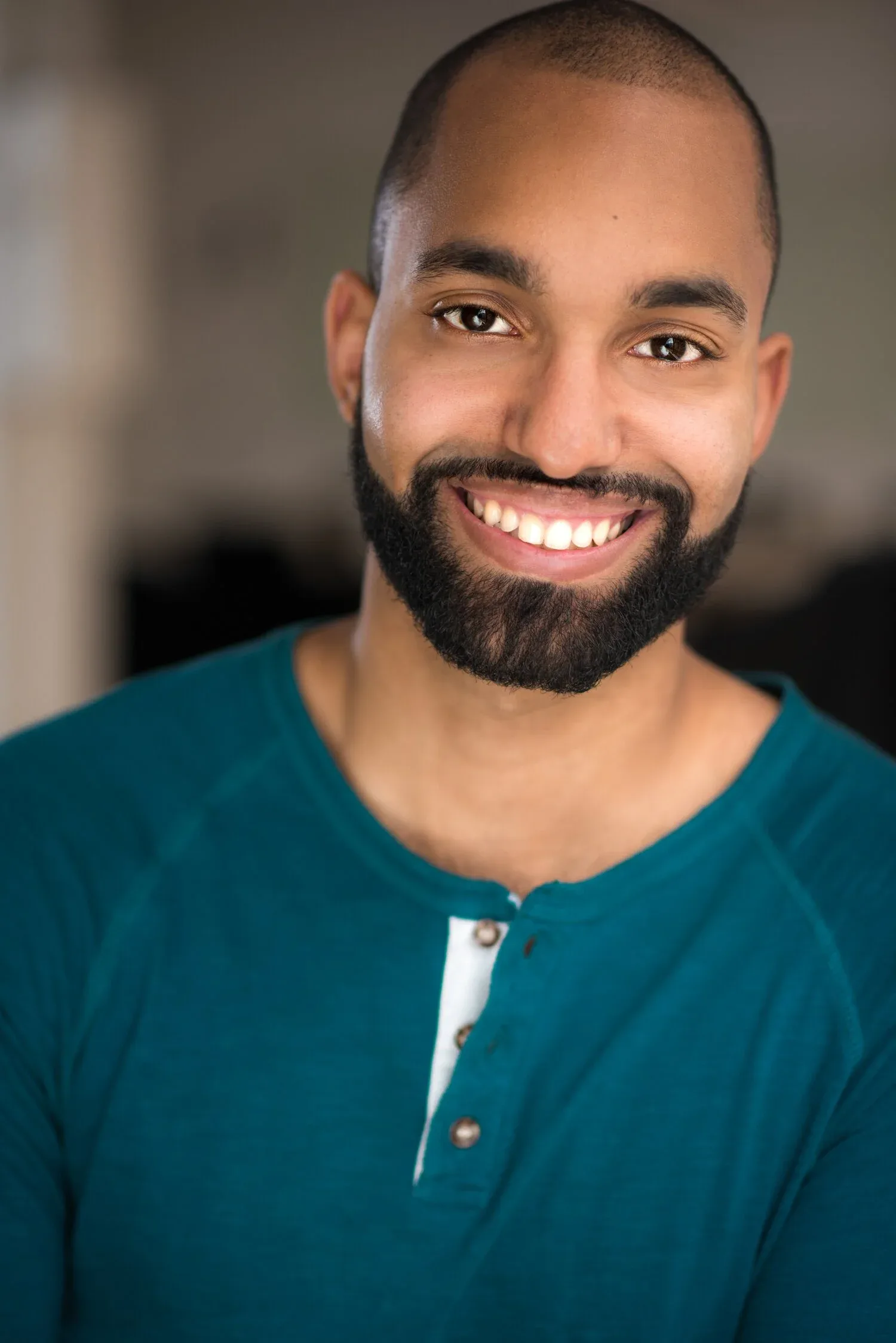Amilcar Javier, bearded and smiling commercial headshot