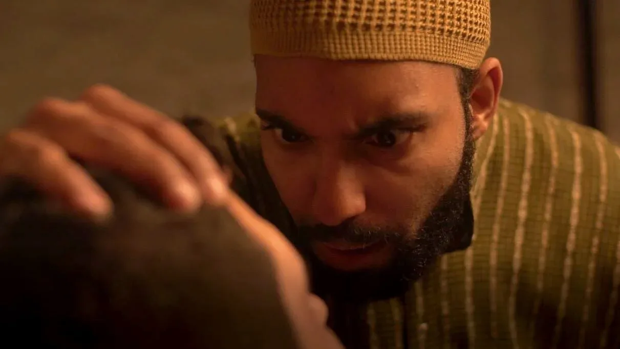 Amilcar Javier as a zealous leader violently interrogating a captive in Invisible Hand