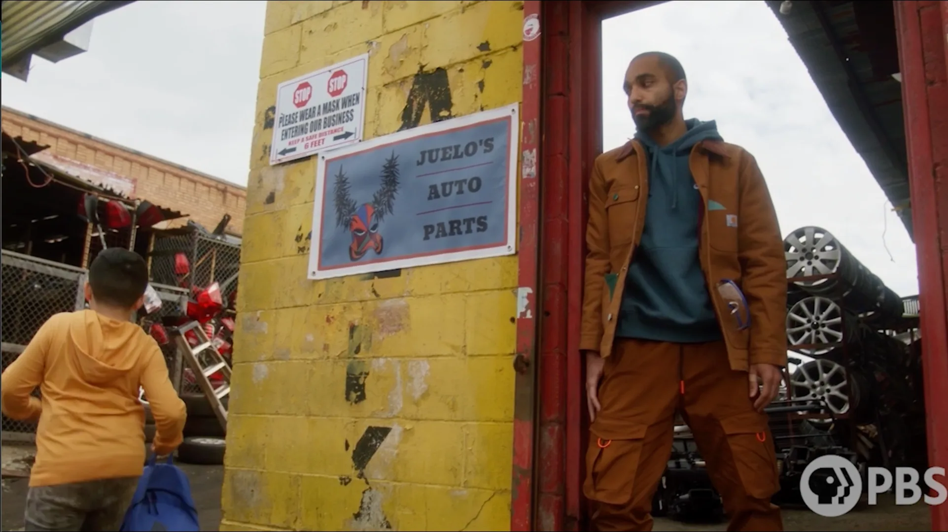 Amilcar Javier as a skeptical junkyard owner in Our Lady Lupe